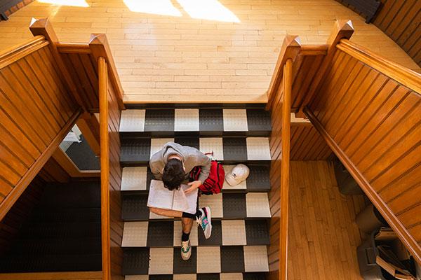 Student studying on stairs